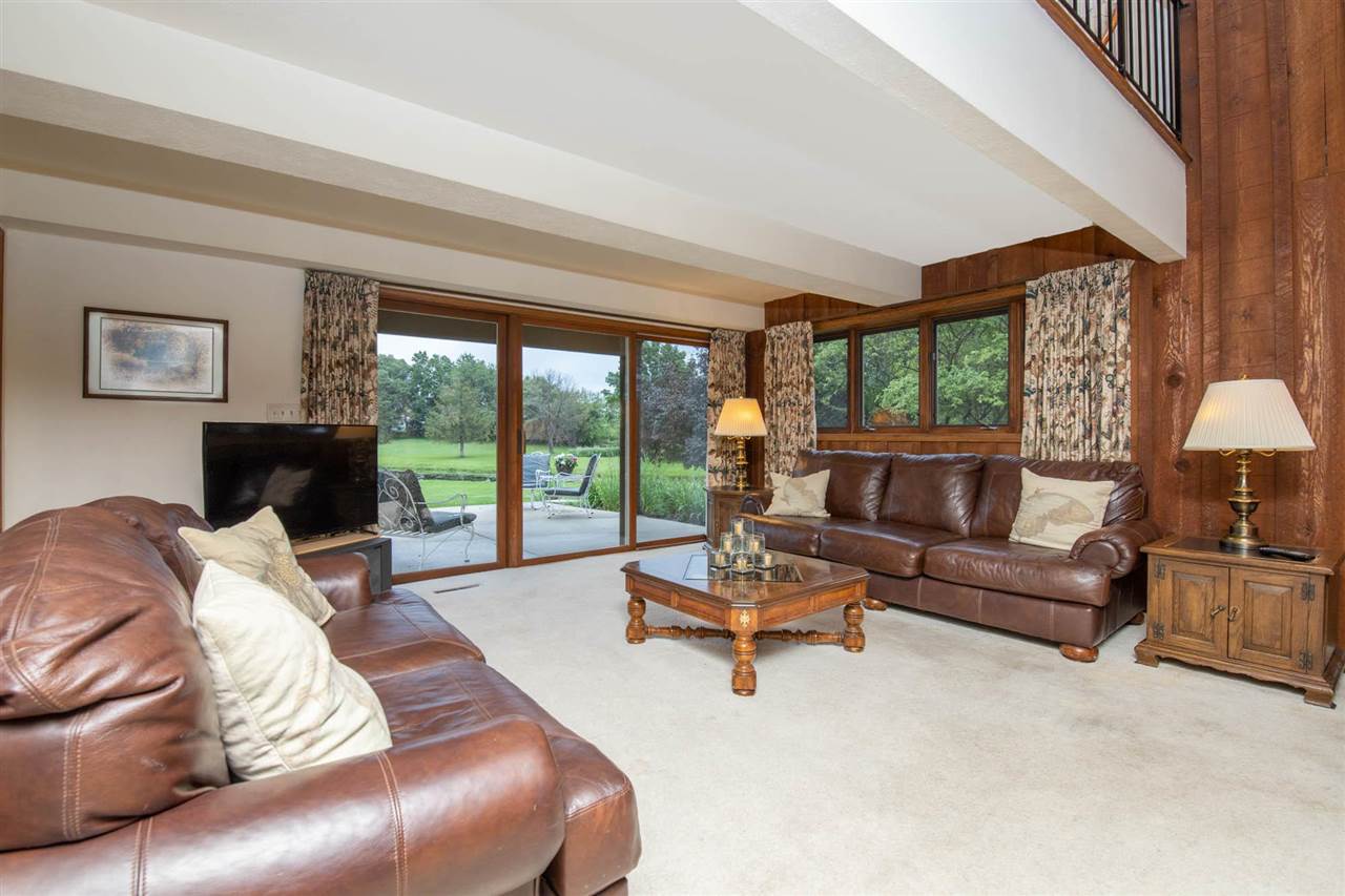 7676 Swanson Road Roscoe, IL 61073 - Photo 28 of 39 a living room with furniture and a large window