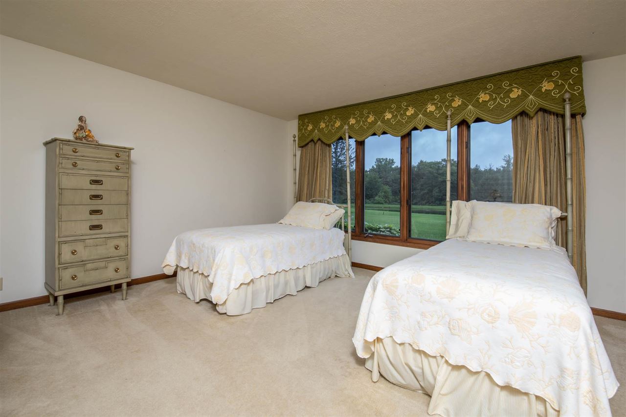 7676 Swanson Road Roscoe, IL 61073 - Photo 29 of 39 a bedroom with bed and a large window