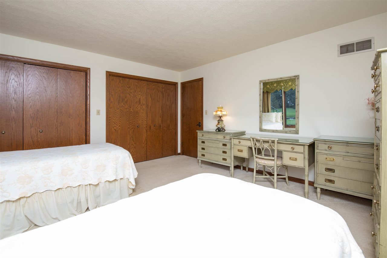7676 Swanson Road Roscoe, IL 61073 - Photo 30 of 39 a bedroom with a bed and a dresser