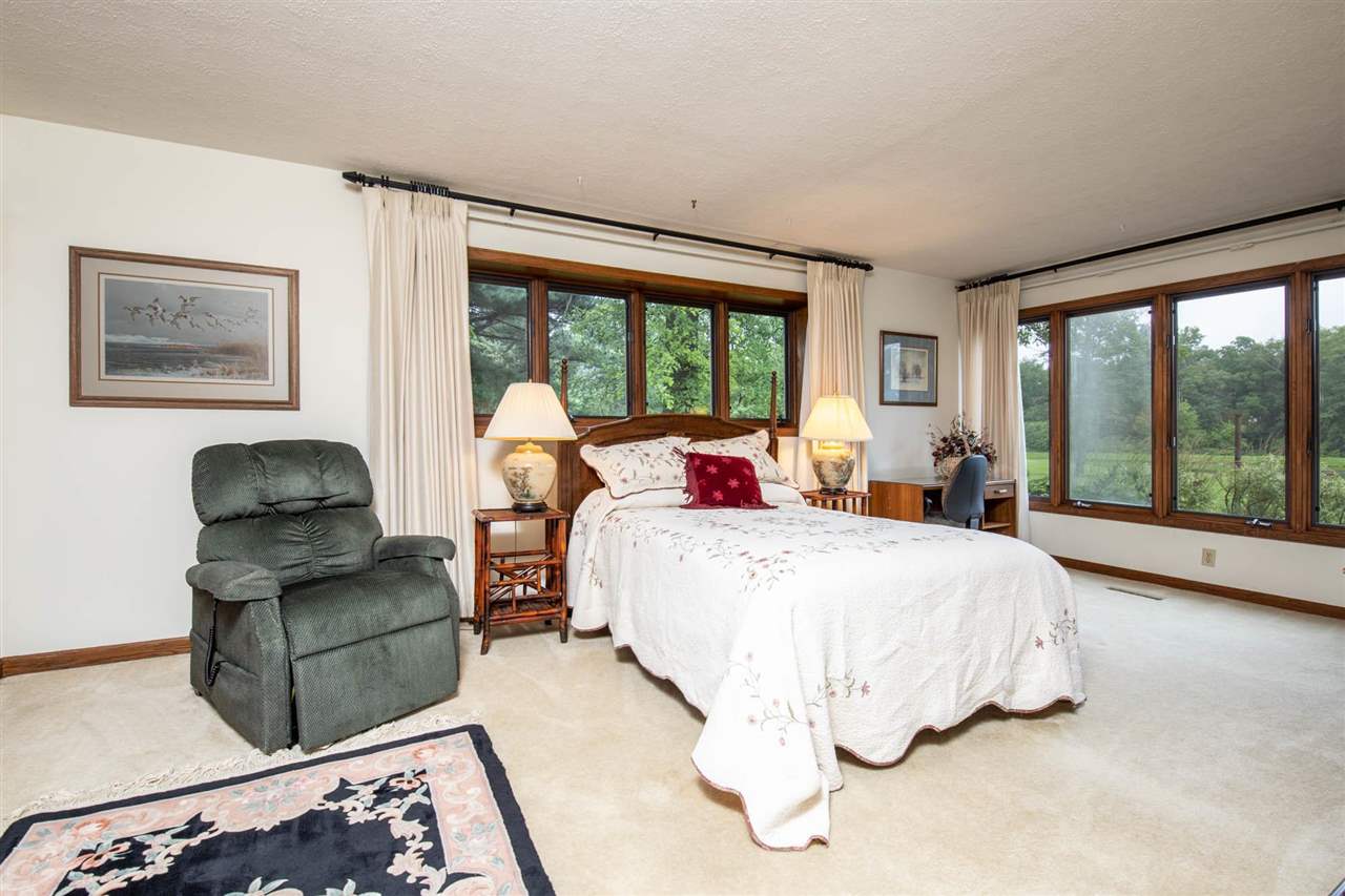 7676 Swanson Road Roscoe, IL 61073 - Photo 33 of 39 a bedroom with bed and glass window