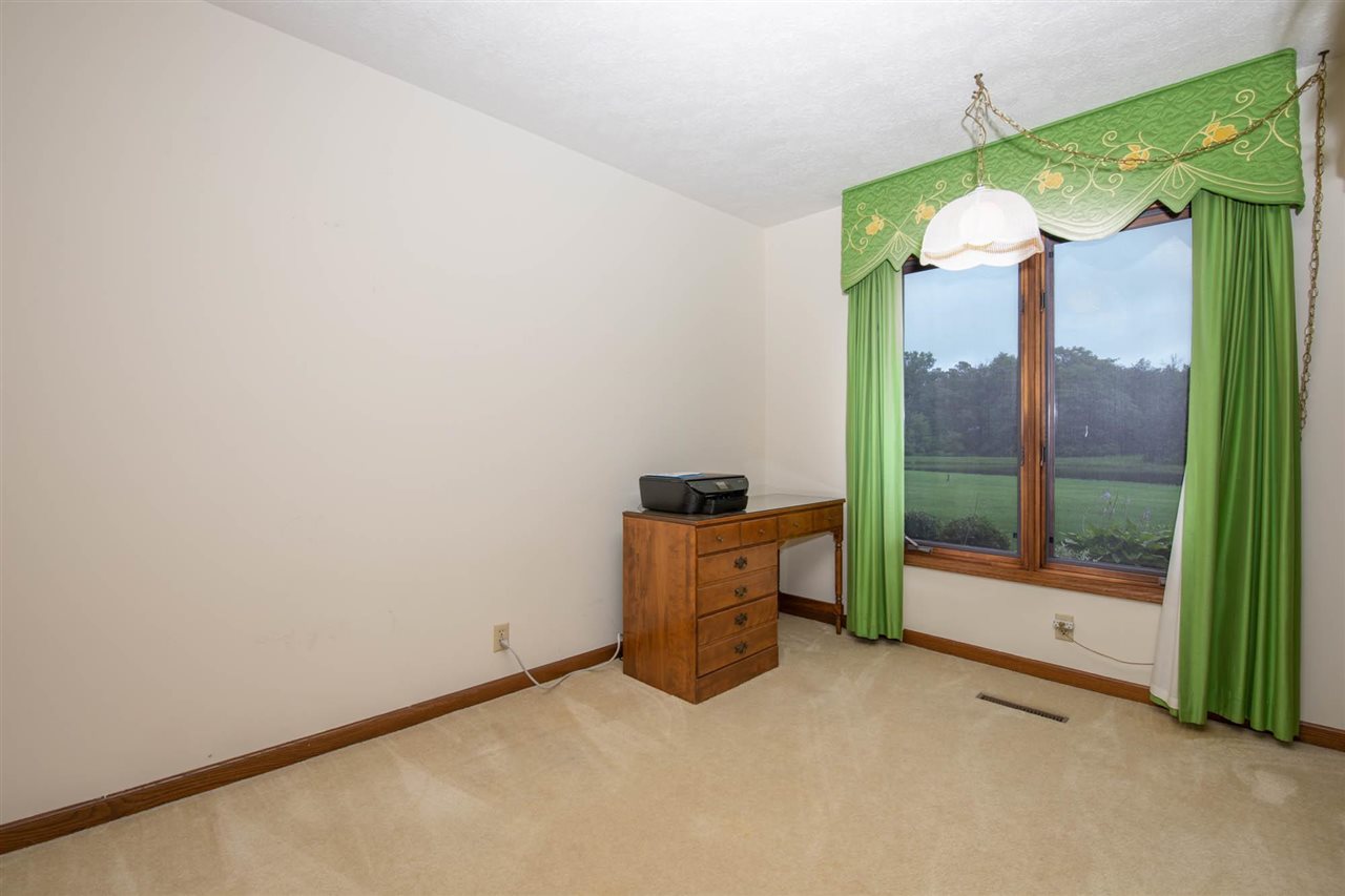 7676 Swanson Road Roscoe, IL 61073 - Photo 35 of 39 an empty room with a mirror and a floor to ceiling window