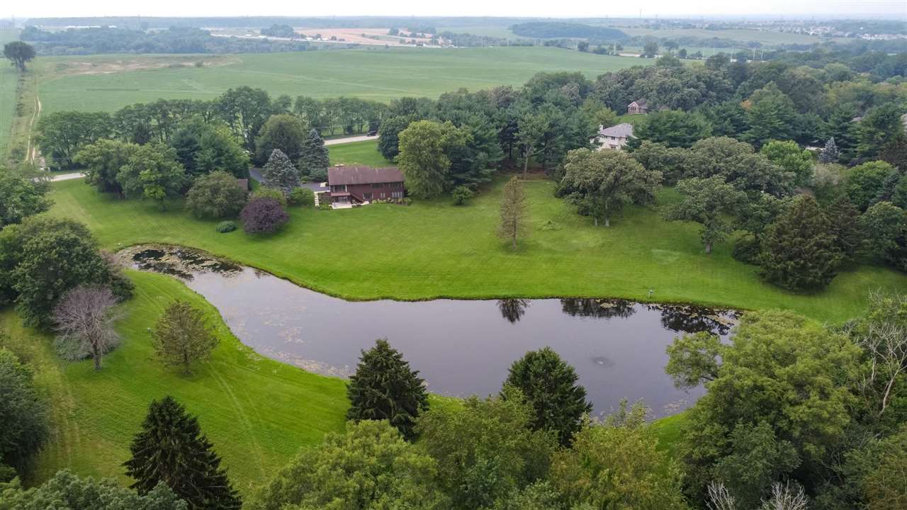 7676 Swanson Road Roscoe, IL 61073 - Photo 39 of 39 an aerial view of a house with a yard and lake view