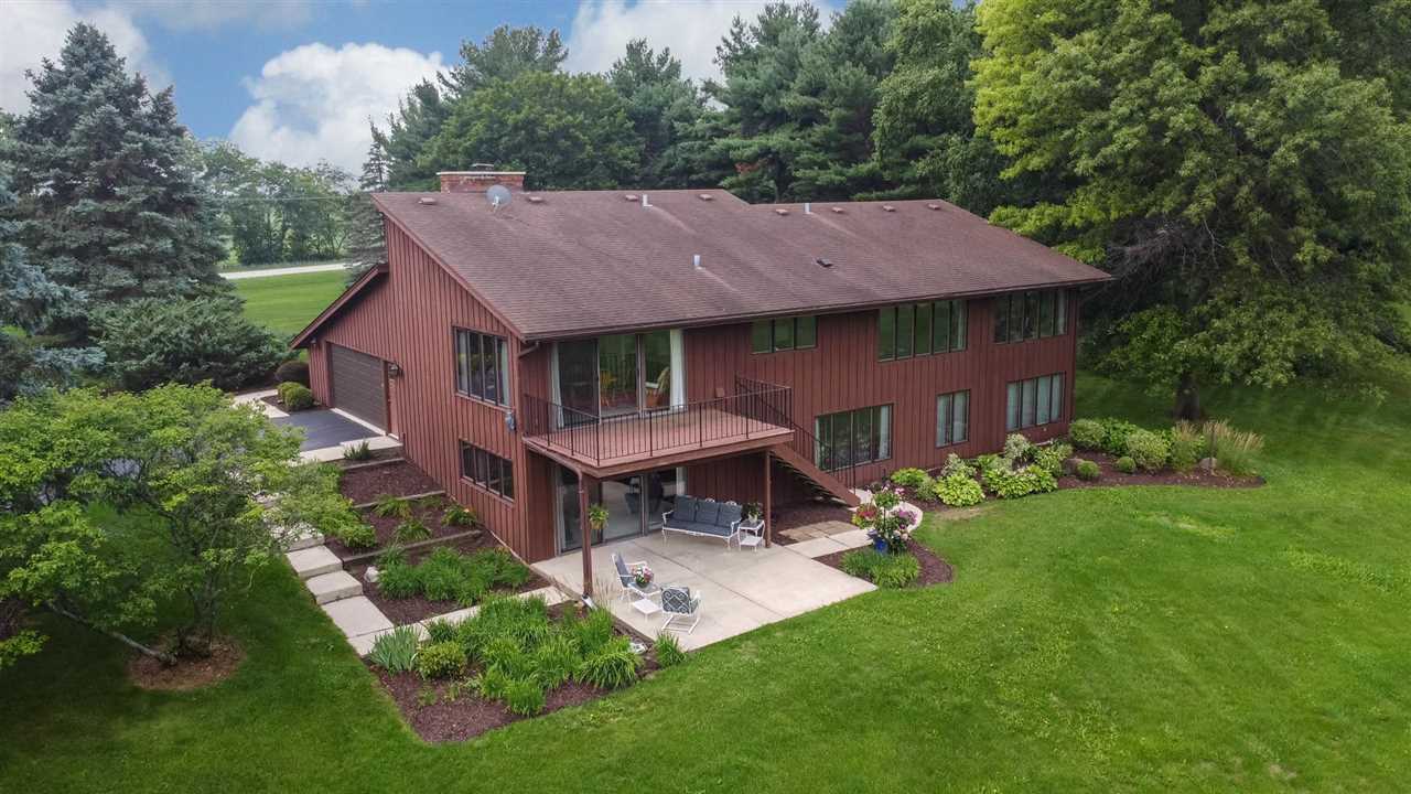 7676 Swanson Road Roscoe, IL 61073 - Photo 4 of 39 a aerial view of a house with a yard table and chairs