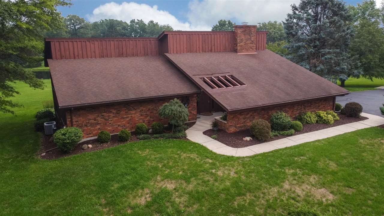7676 Swanson Road Roscoe, IL 61073 - Photo 5 of 39 a view of a backyard with plants and a garden