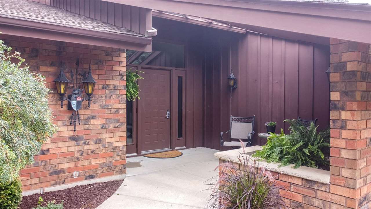 7676 Swanson Road Roscoe, IL 61073 - Photo 6 of 39 a couple of potted plants in front of door