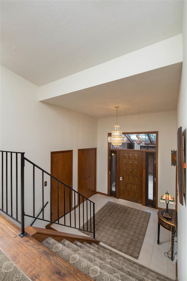7676 Swanson Road Roscoe, IL 61073 - Photo 7 of 39 a view of a livingroom with stairs and furniture