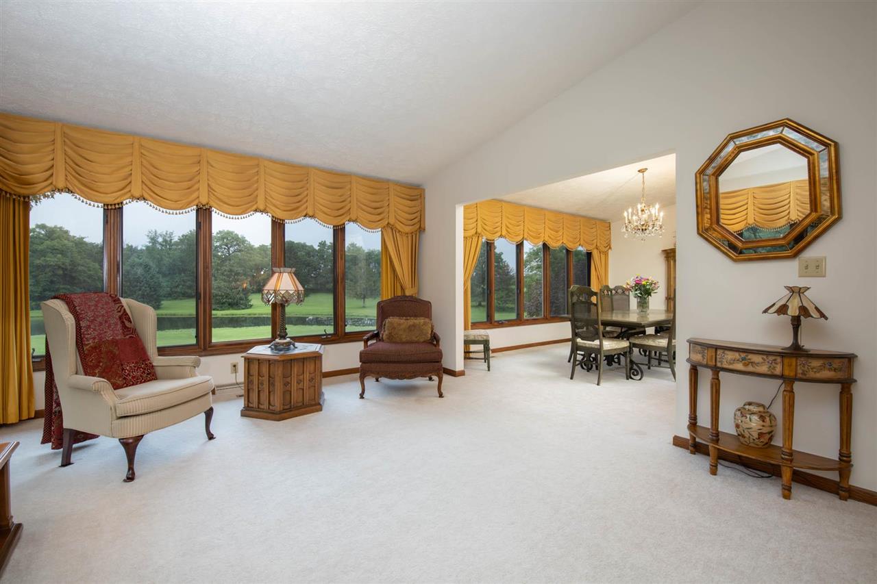 7676 Swanson Road Roscoe, IL 61073 - Photo 9 of 39 a living room with furniture and a floor to ceiling window