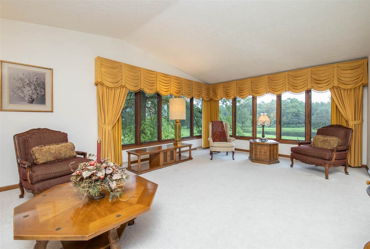 7676 Swanson Road Roscoe, IL 61073 - Photo 10 of 39 a living room with furniture and a large window