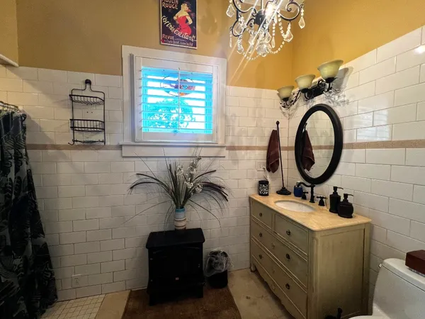 a bathroom with a toilet a sink and a mirror