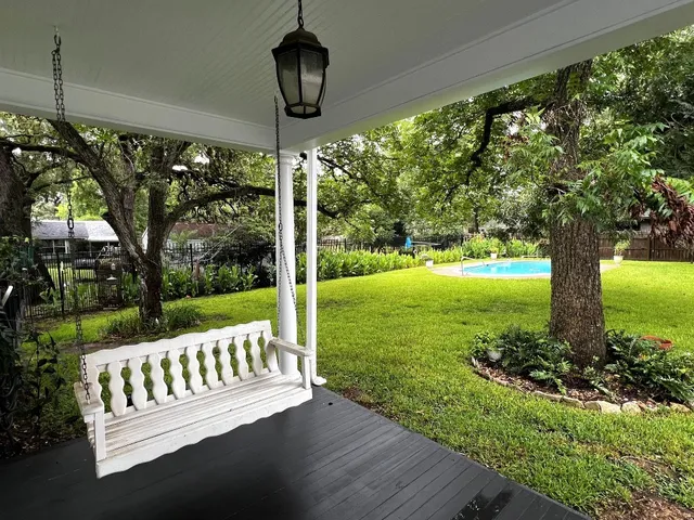 a view of a chairs and table in patio with a yard