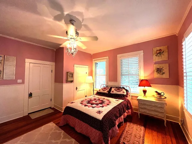a bedroom with a bed and a chandelier