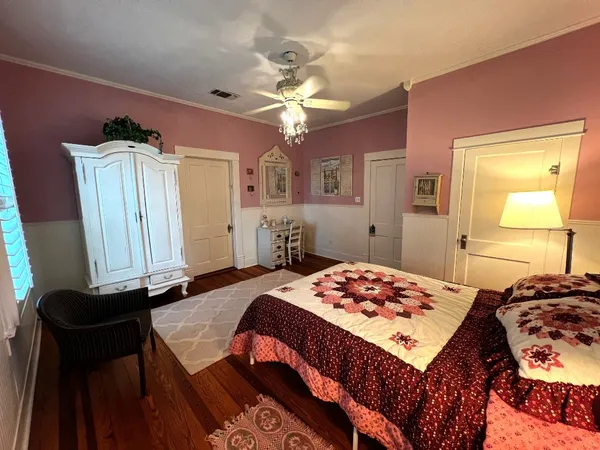 a bedroom with a bed and a chandelier