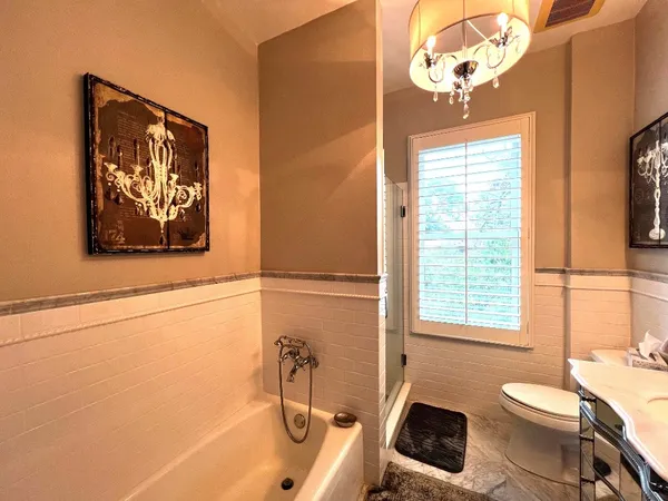a bathroom with a toilet a sink and bathtub