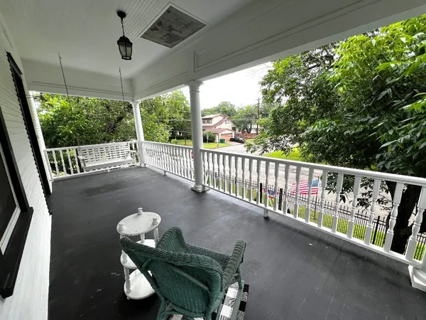 a view of balcony with furniture