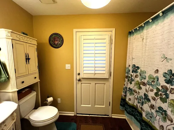 a bathroom with a toilet a sink and mirror