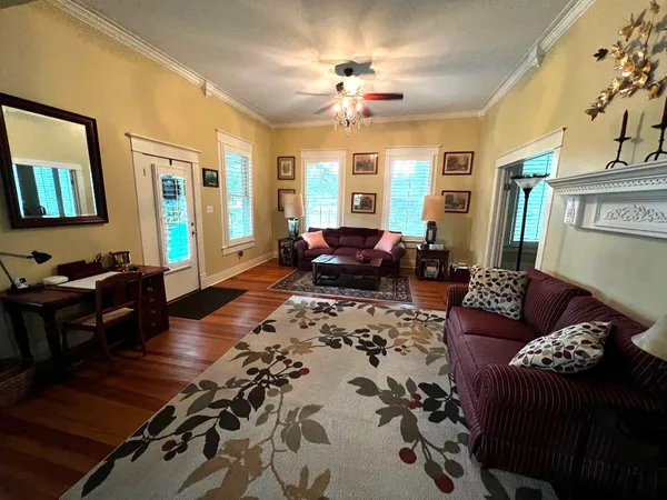 a living room with furniture and wooden floor
