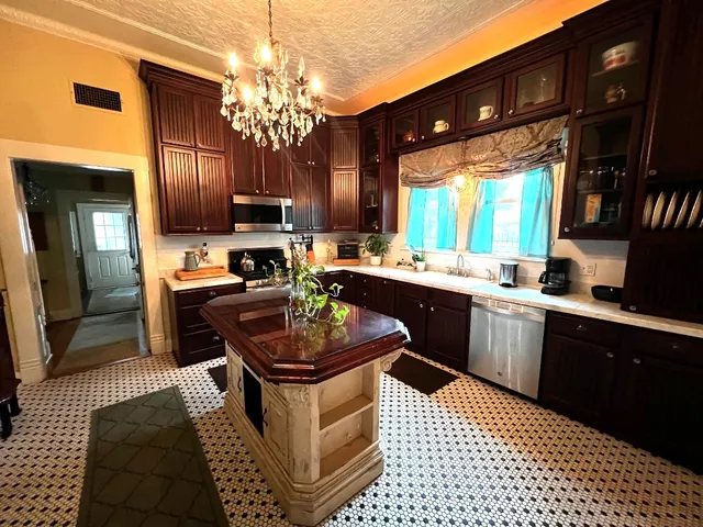 a kitchen with a sink stove and cabinets