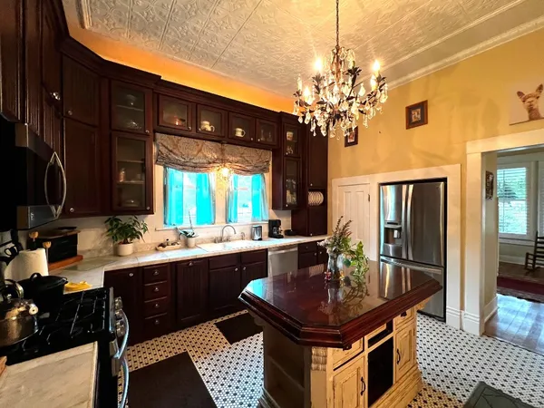 a kitchen with a table chairs and microwave