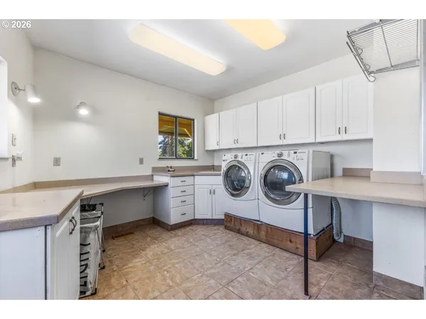 a utility room with sink dryer and washer