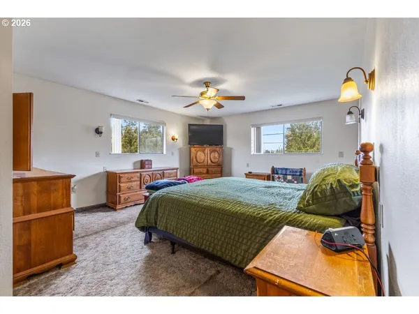 a bedroom with a bed window and dresser