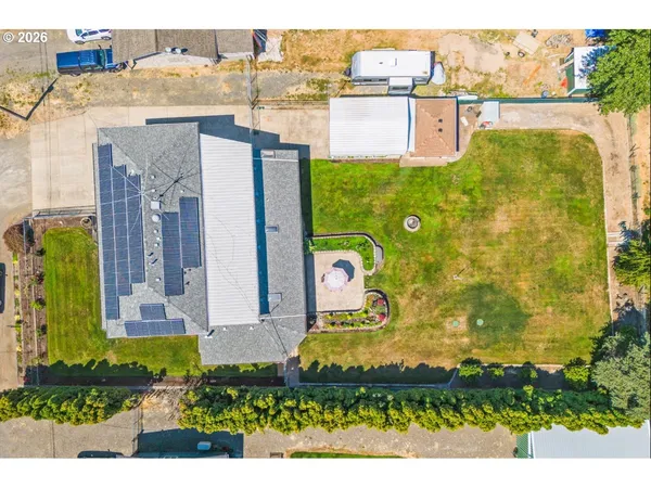 an aerial view of residential houses with outdoor space and parking