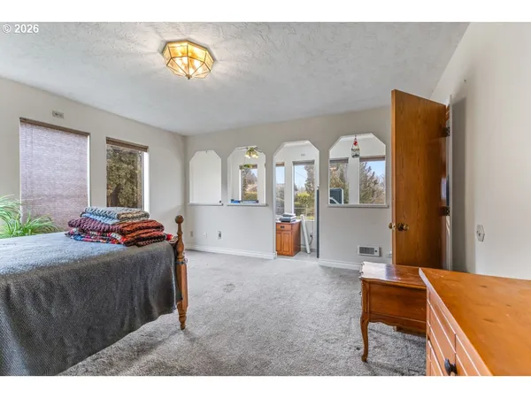a bedroom with furniture and a wooden floor