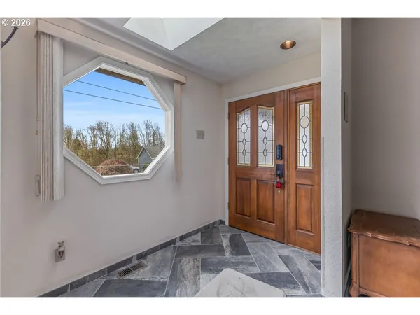 a view of an entryway with wooden floor