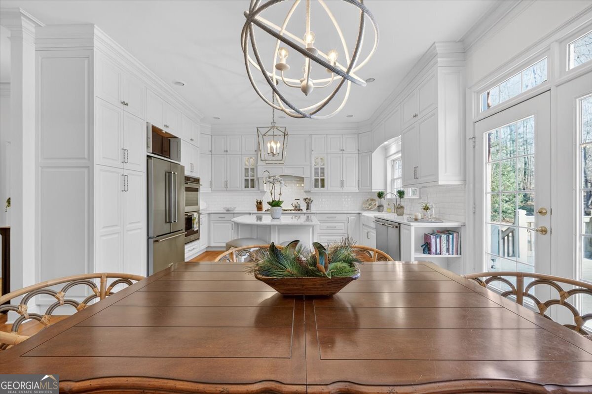 242 Pebblebrook Lane Macon, GA 31220 - Photo 14 of 45 a kitchen with stainless steel appliances granite countertop a dining table chairs and a large window