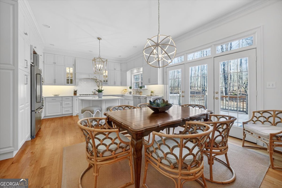 242 Pebblebrook Lane Macon, GA 31220 - Photo 15 of 45 a view of a dining room with furniture wooden floor and chandelier