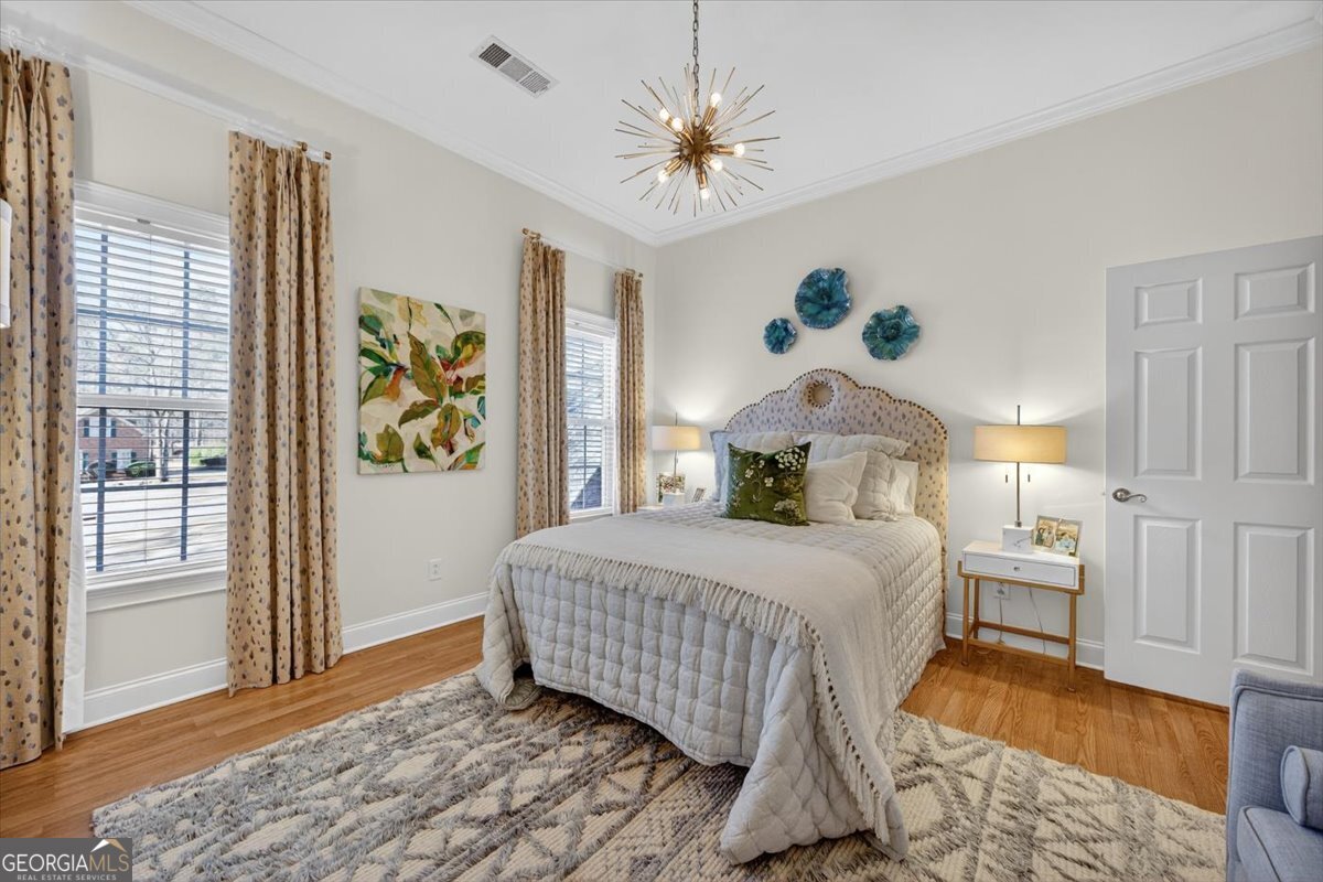 242 Pebblebrook Lane Macon, GA 31220 - Photo 27 of 45 a bedroom with a bed and wooden floor