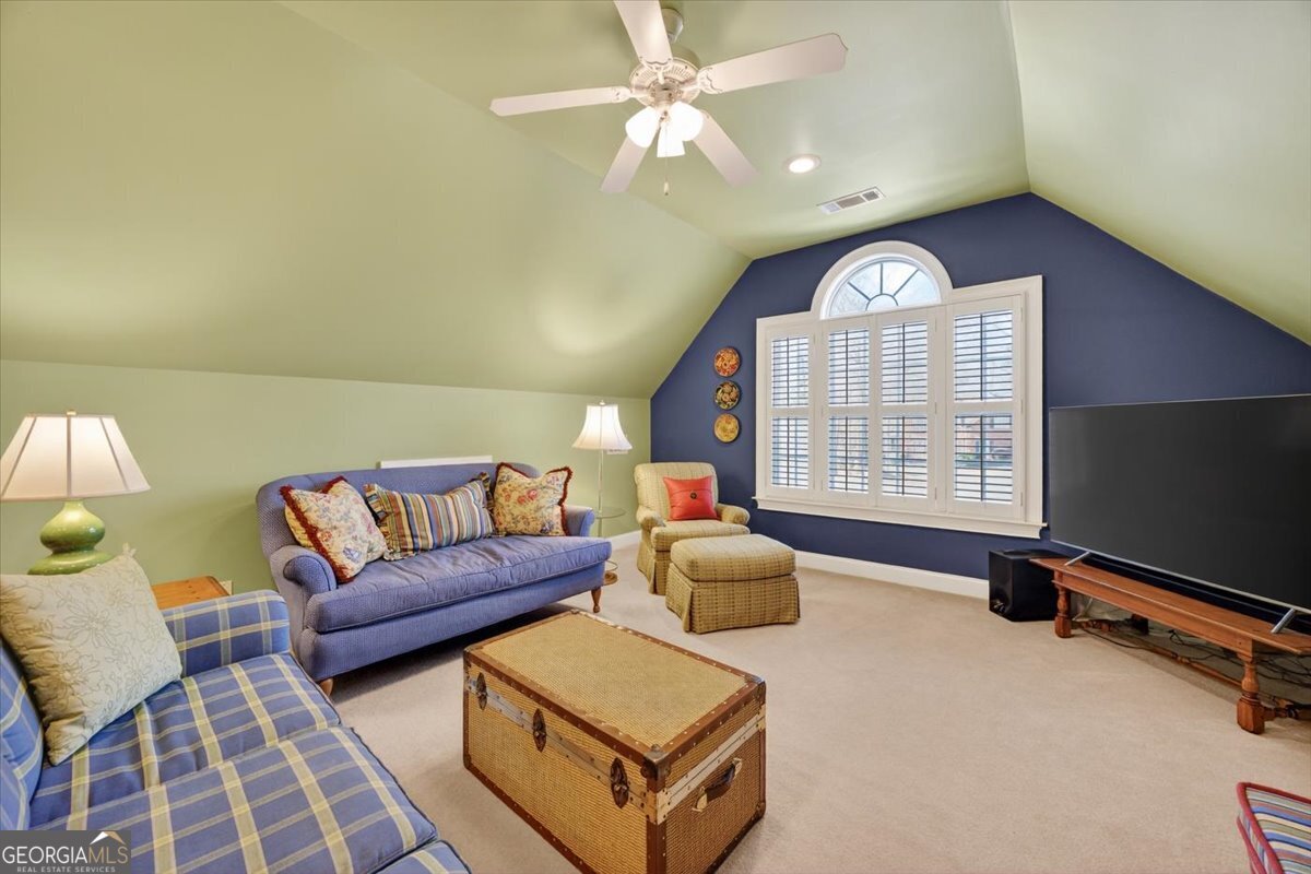 242 Pebblebrook Lane Macon, GA 31220 - Photo 30 of 45 a living room with furniture a chandelier and a flat screen tv