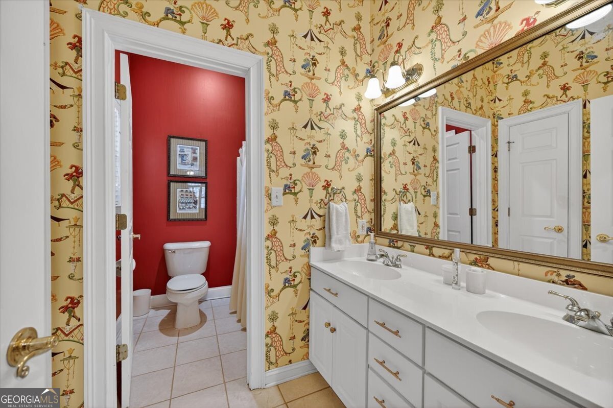 242 Pebblebrook Lane Macon, GA 31220 - Photo 32 of 45 a bathroom with a sink and mirror with toilet