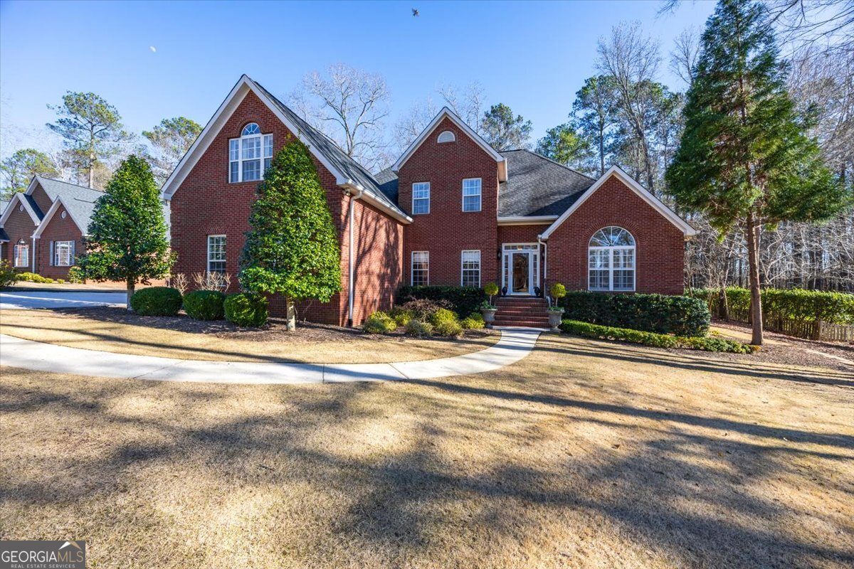 242 Pebblebrook Lane Macon, GA 31220 - Photo 43 of 45 a front view of a house with a yard and garage