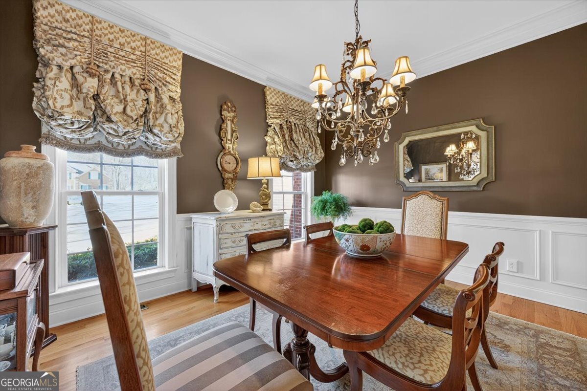 242 Pebblebrook Lane Macon, GA 31220 - Photo 9 of 45 a view of a dining room with furniture a chandelier and wooden floor