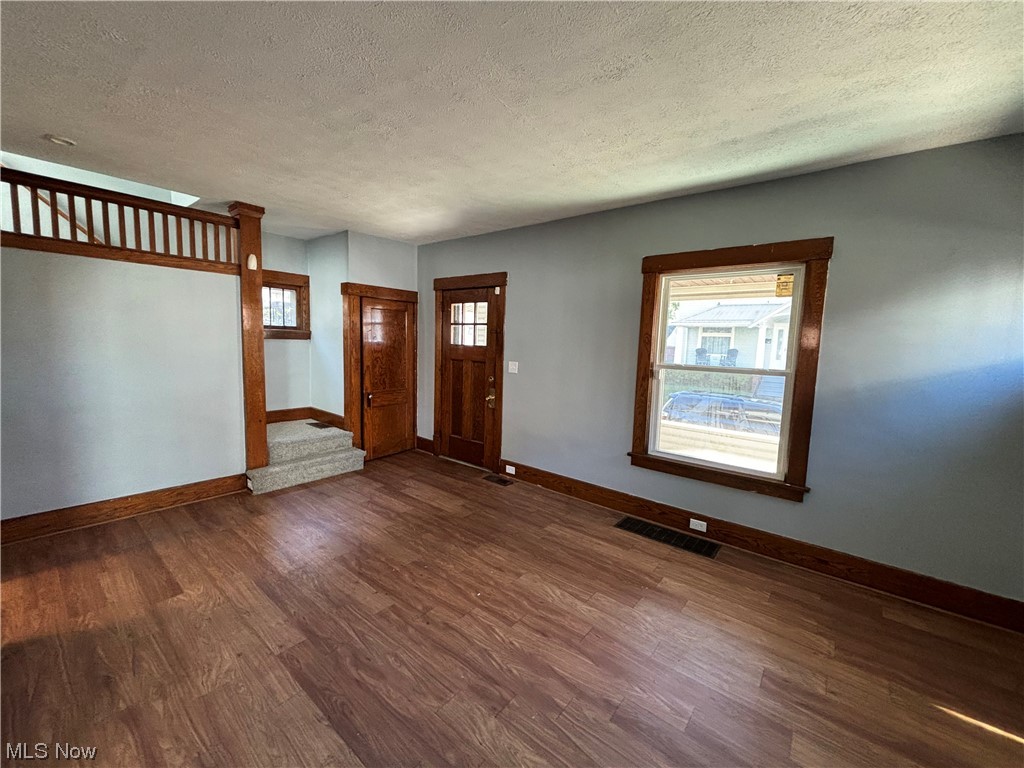 2711 11th Street Northwest Canton, OH 44708 - Photo 14 of 16 Entrance foyer with a wealth of natural light, a textured ceiling, and dark wood-type flooring
