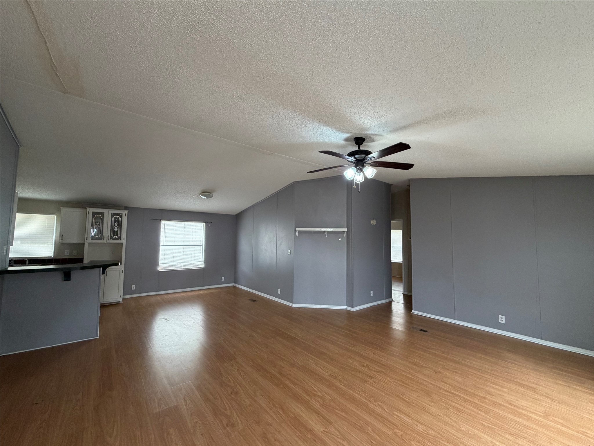 12609 Dessau Road, Unit 410 Austin, TX 78754 - Photo 3 of 11 Spacious living area featuring wood-finish flooring, a ceiling fan with integrated lighting, and neutral wall tones
