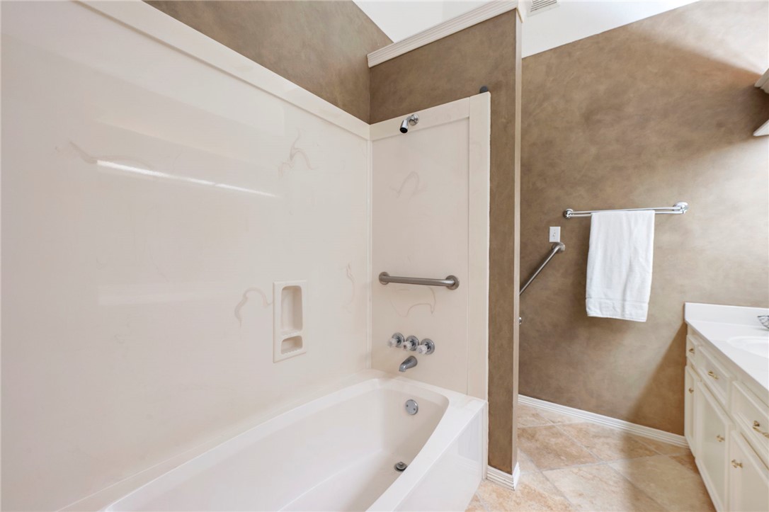 713 Willow Loop College Station, TX 77845 - Photo 23 of 39 a bathroom with a bathtub and a shower