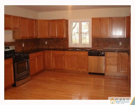 32 Parkerson Road Edison, NJ 08817 - Photo 3 of 4 a kitchen with stainless steel appliances granite countertop a stove a sink and a microwave