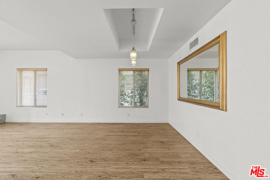 123 Galleon Street, Unit B Marina del Rey, CA 90292 - Photo 14 of 43 a view of an empty room with a window and wooden floor