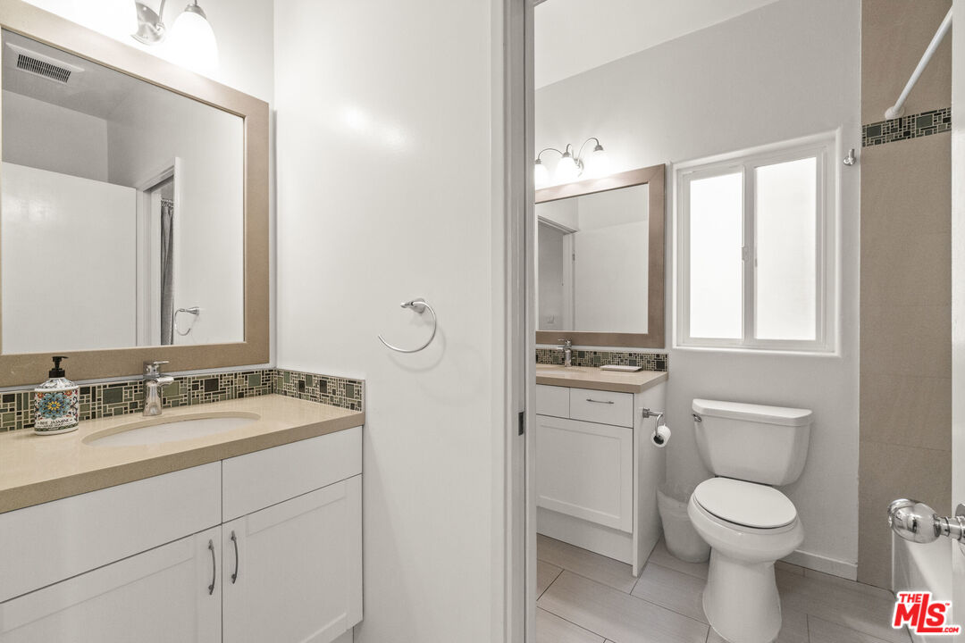 123 Galleon Street, Unit B Marina del Rey, CA 90292 - Photo 16 of 43 a bathroom with a toilet sink vanity and mirror