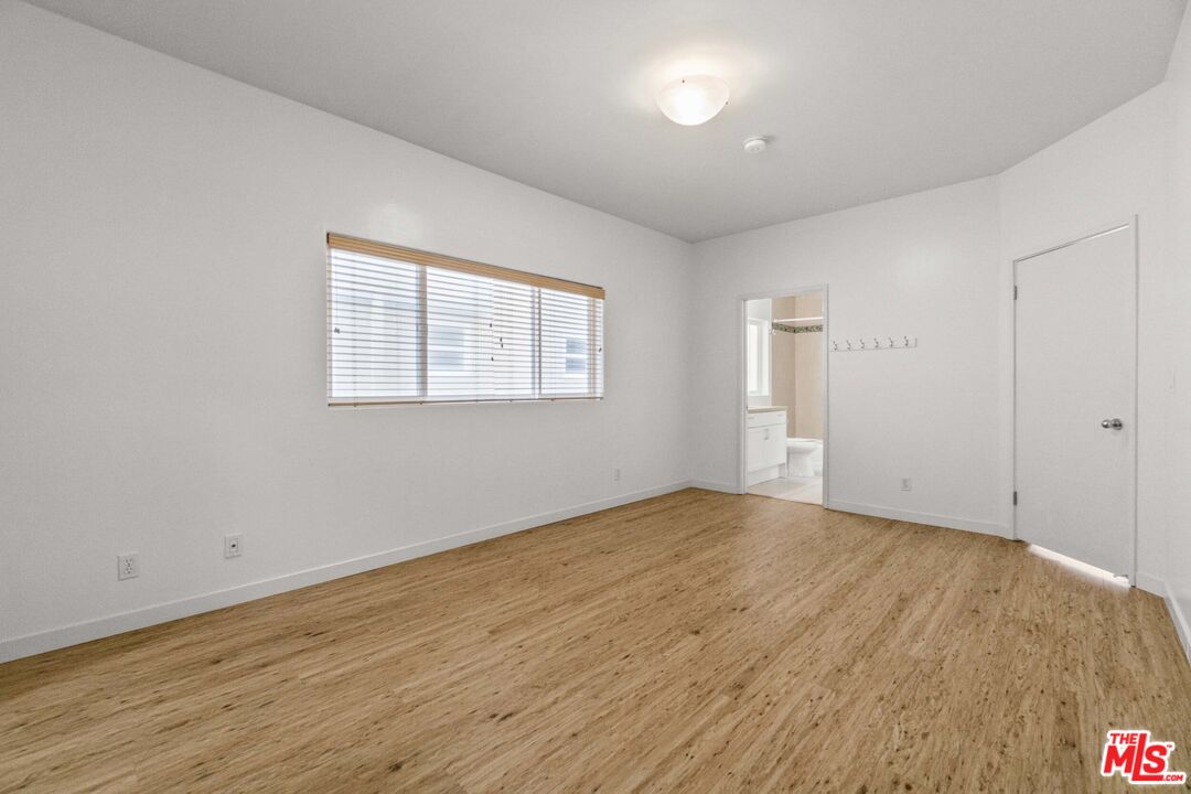123 Galleon Street, Unit B Marina del Rey, CA 90292 - Photo 17 of 43 a view of an empty room with wooden floor and a window