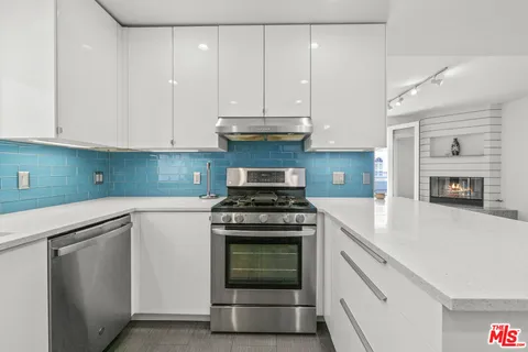 a stove top oven sitting inside of a kitchen