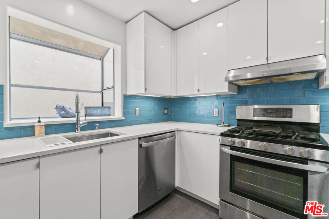 123 Galleon Street, Unit B Marina del Rey, CA 90292 - Photo 31 of 43 a kitchen with cabinets appliances and a sink