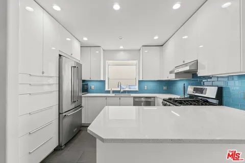 a kitchen with a stove a refrigerator and a sink