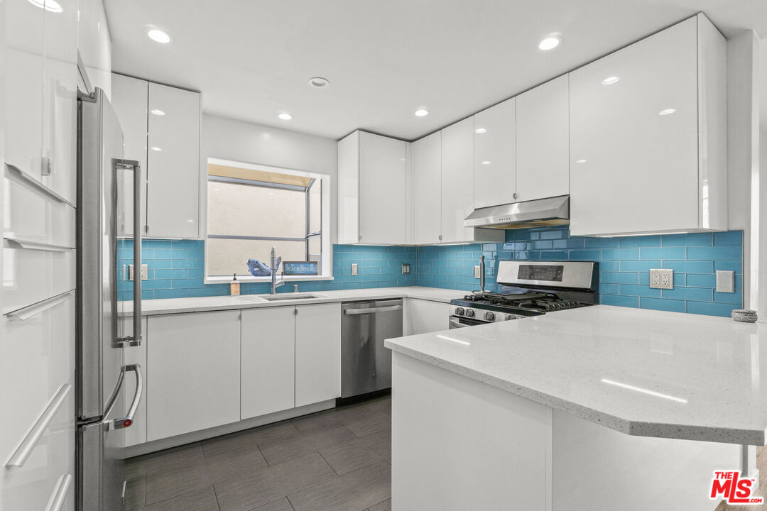 123 Galleon Street, Unit B Marina del Rey, CA 90292 - Photo 10 of 43 a kitchen with stainless steel appliances a sink stove and refrigerator