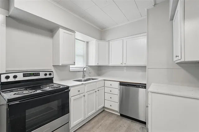 a kitchen with cabinets appliances and a sink