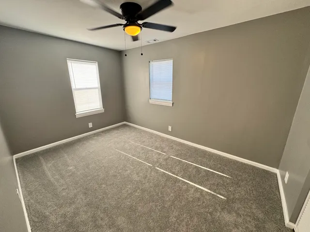 a bedroom with a bed and a potted plant