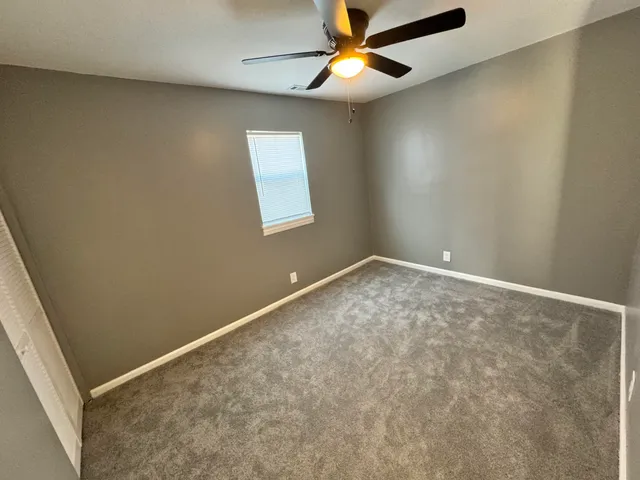 a kitchen with a refrigerator and a stove top oven