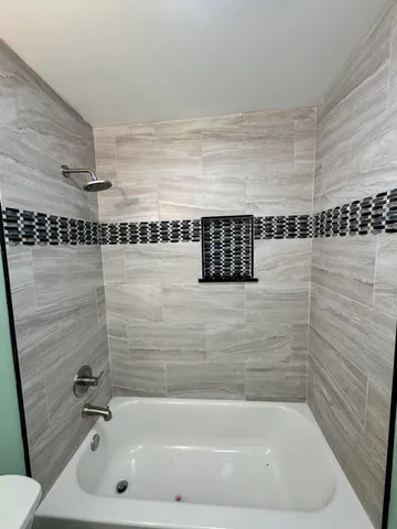 a bedroom with a bed a window and potted plant