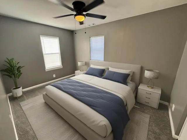 an empty room with windows and view of a bathroom